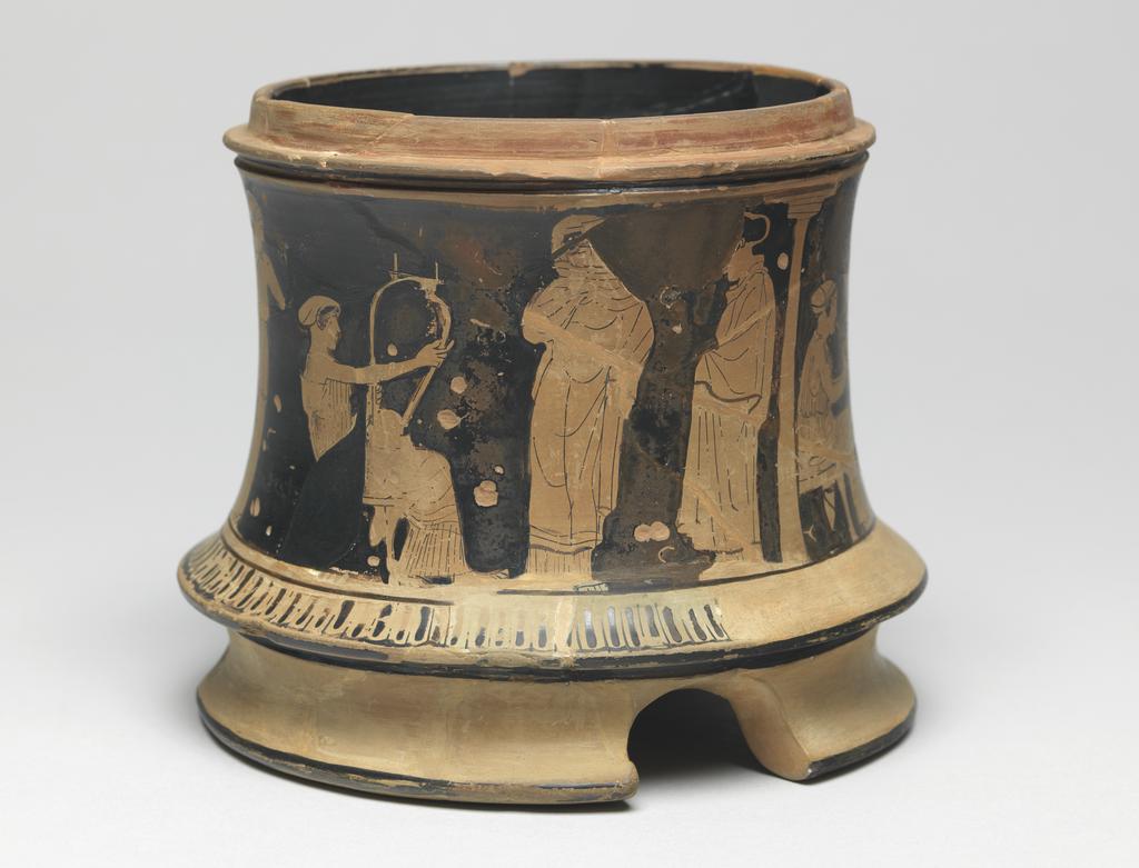 An image of Pyxis. Cosmetic vessel. Women indoors. Production Place: Athens. Clay, red-figured, diameter 0.11 m, height 0.127 m, 460 B.C. Classical Period.