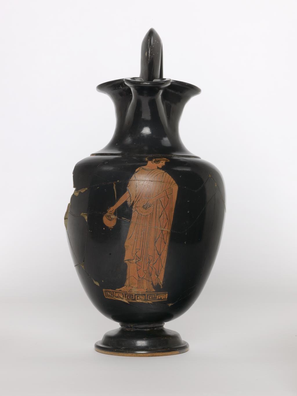 An image of Vessel. Oinochoe/Jug. Oinochoe (shape 1), woman pouring libation. Find Spot: Nola (?) Campania, Italy. Production Place: Greece, Attica, Athens. Clay, red-figured, height 0.26 m, width 0.145 m. 480 B.C. Classical Period.