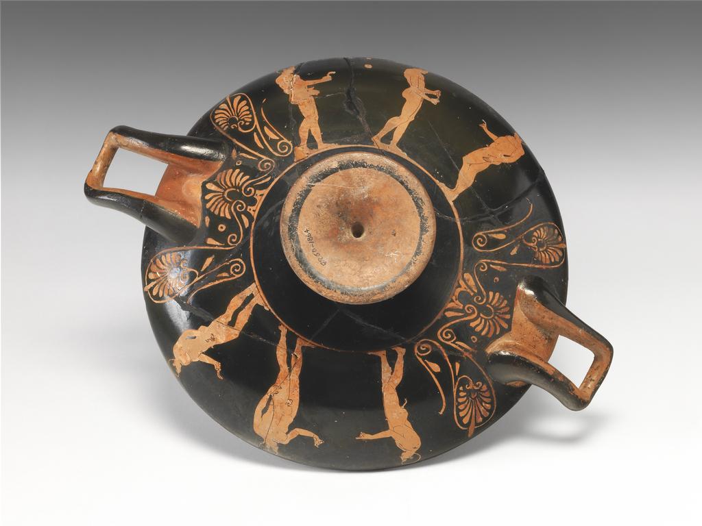 An image of Vessel/Cup. I, athlete, A and B, athletes. Production Place: Athens, Greece. Find Spot: Vulci Etruria Italy. Red-figured, clay, height 0.087 m, width 0.288 m, diameter 0.215 m, diameter, interior, 0.103 m. 430 B.C. Classical Greek Period.