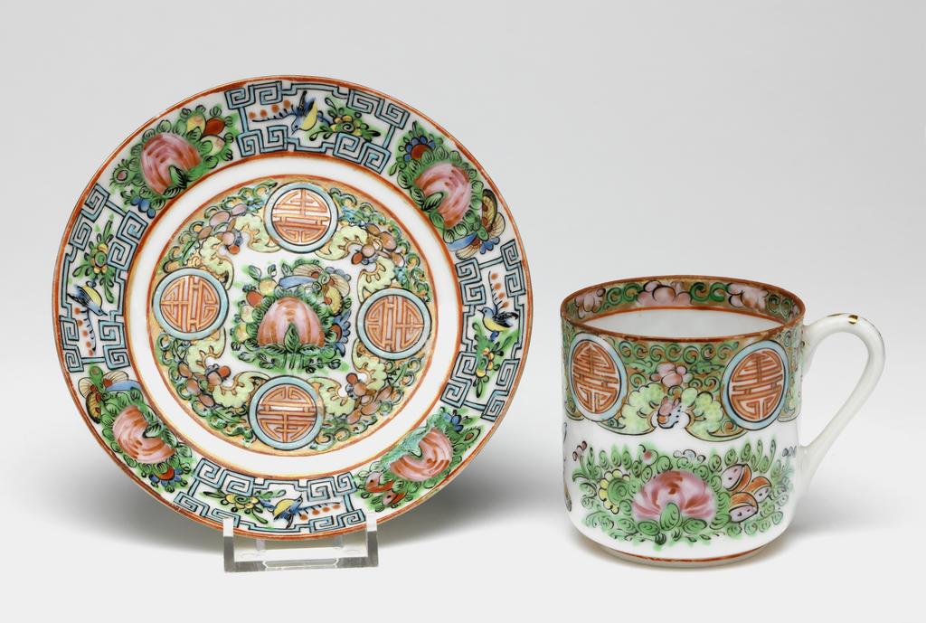 An image of A tea cup and saucer, famille rose export ware. With ‘MADE IN CHINA’ stamped underneath both items. Porcelain, enamelled, 1900-1925. Chinese.
