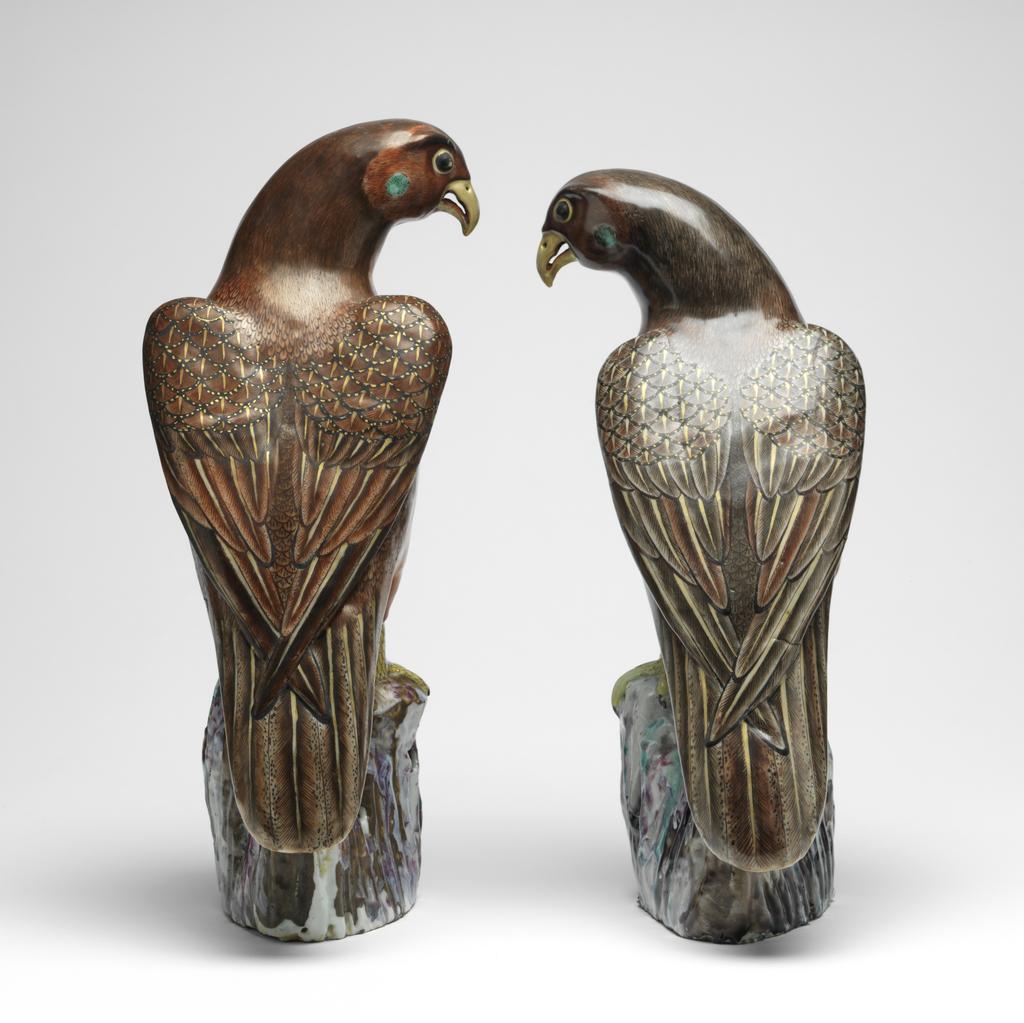 An image of Hawk. Animal Figure. One of a pair, Red and brown, on a pierced rock or branch. Hard-paste porcelain, height 35.1 cm, 1725-1775. Chinese.