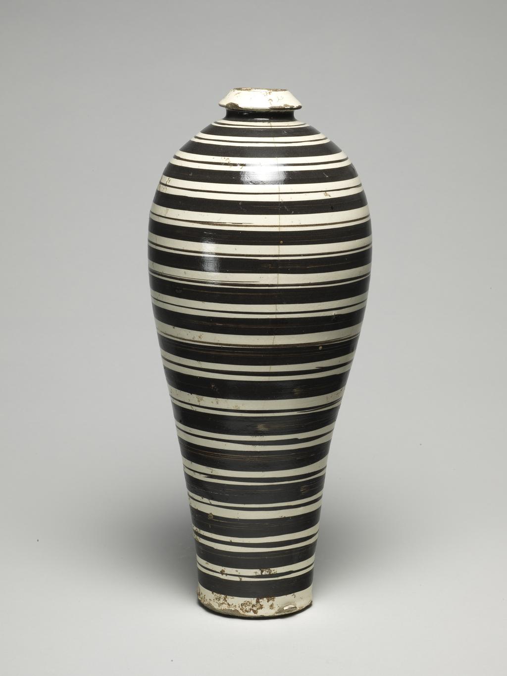 An image of Vase (mei ping), with black circles. Tz'u chou ware. Stoneware, height 35.5 cm. Song Dynasty (960-1279). Chinese.