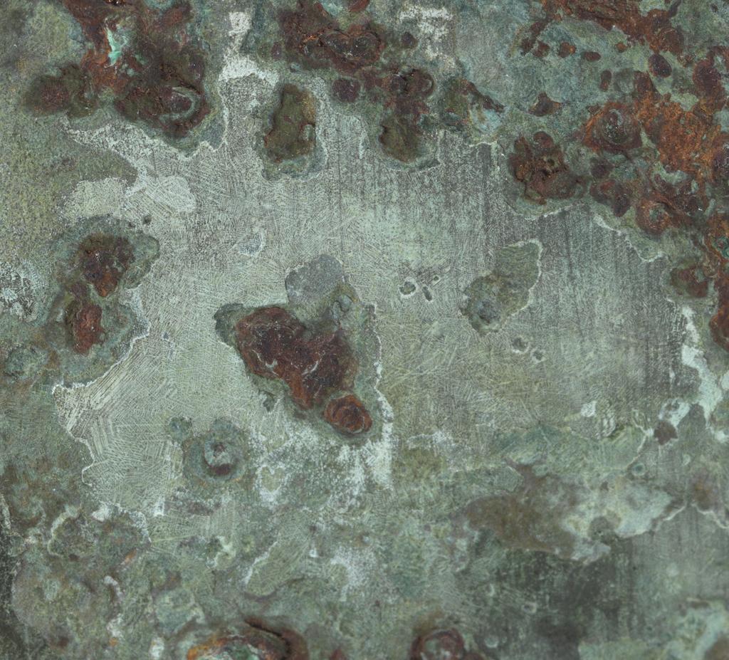 An image of Axe head. The blade, socket, and socket cap all one piece of metal. The blade is flanked by two tigers. On the blade is a coiled dragon, a conventionalised dragon's head, and a t'ao t'ieh mask in the piece of blade at the back. On the cap is an elephant's head with horse's legs and a tiger's head at the back. Bronze, height 11.1 cm, length 14.6 cm, circa 500-249 B.C. Chou dynasty (1122-249 BC). Chinese Warring States period.