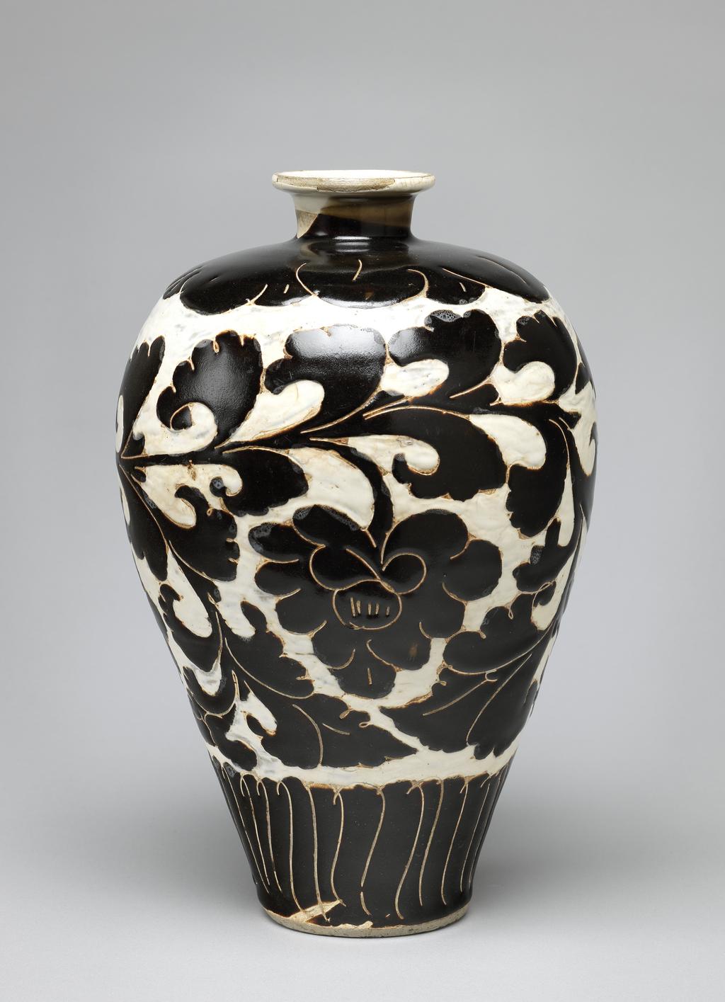 An image of Vase. Tz’u chou ware. Buff stoneware, with incised floral designs painted in dark brown. The ground has been cut away and filled in with white. Height 29.2 cm, diameter 19.1 cm, 960-1280. Song Dynasty (960-1279). Chinese.