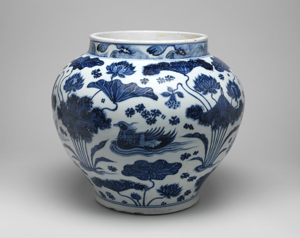 An image of Guan Jar. Painted underglaze in blue with mandarin ducks swimming between lotus and other aquatic plants. Hard paste porcelain, height 30.5cm, circa 1330-1368. Chinese. Yuan Dynasty (1279-1368). Made for Chinese domestic market.