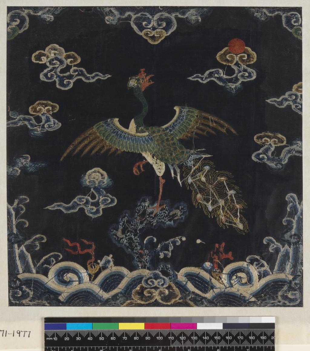 An image of Textiles. Mandarin Square. Unknown maker, China. Peacock feather on pheasant's head. Satin stitch, stem stitch, couched stitch, hem stitch, and laid work. Peacock perched on rock against a background of sky, clouds and waves, set in a wave and mountain border, with lucky symbols, clouds and a red sun above. Silk and metallic embroidery on satin - blues, greens, beige, white, red and gold. Length, whole, 29 cm, width, whole, 28.5 cm, circa 1700-circa 1799. Chinese. Acquisition Credit: Given by Mrs. Soame Jenyns, in accordance with the wishes of her late husband, Soame Jenyns.