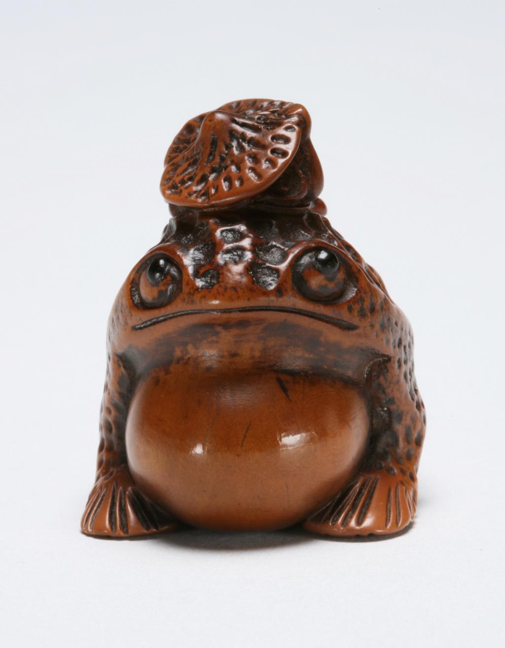 An image of Netsuke. Gama Sennin on top of a giant toad. Unknown maker, Japan. Boxwood, carved, eyes inlaid with horn, 1800-1850.
