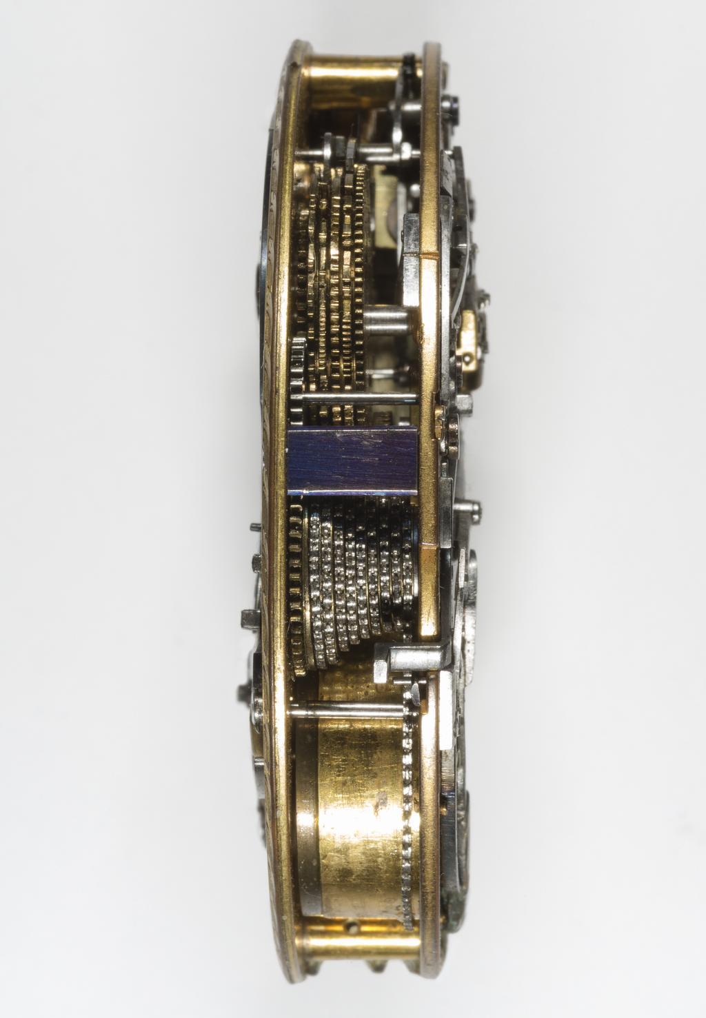 An image of Singing Bird Watch. Bassereau, Jean Hillaire, watchmaker (French, d. 1806, Paris, Colmar). Gold case enamelled in dark and pale blue, the top having a circular hinged panel decorated in painted enamel with a bird perched on a tree in a landscape. The watch has a singing bird automaton which springs up when the hinged panel is open. The watch face is visible through a circular aperture in the back of the case. The maker of the movement was Hillaire Bassereau, and is inscribed 'Hilre Bassereau n. 532, Int Et Fect.'. Marks on the case: (1) Maker's mark JS or IS with a pellet above and below within a lozenge. (2) Assay mark for a second standard gold 1798-1809. (3) Exercise mark for medium-sized gold and silver 1798-1809. (4) An illegible mark with a 2 on the right side. (5) Impressed mark: 150. (6) Dealer's scratch mark: 55041. Gold dial, steel hands, blued, gold and enamel case, height 7.3 cm, width 6.2 cm, depth 1.9 cm, circa 1798-1809. The case bears the Paris assay and excise marks for 1798-1809. The movement is a little earlier than the case, probably about 1790.