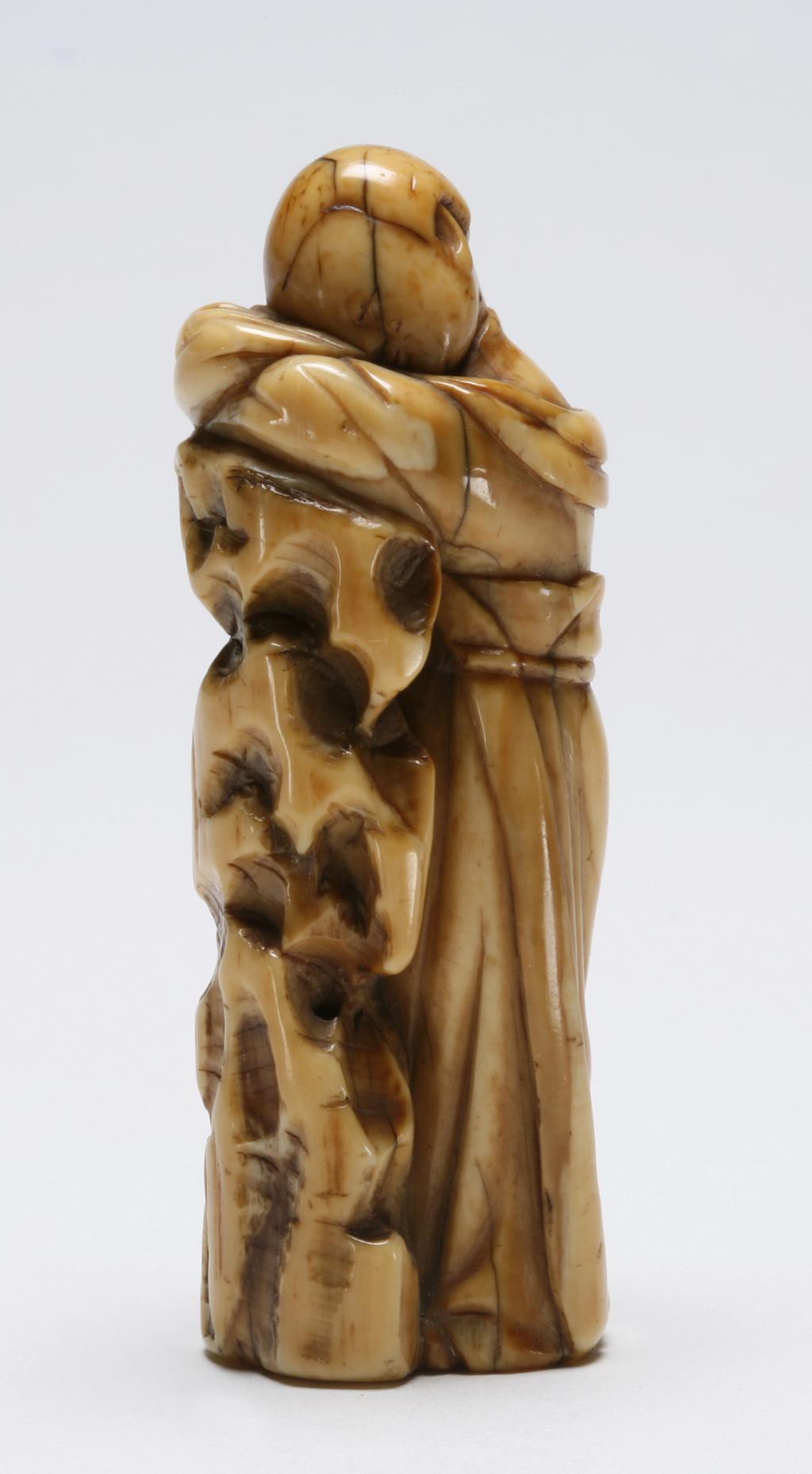 An image of Okimono. Unknown maker, Japan. A young lady fast asleep standing against a pillar of rock. Ivory, carved, 1700-1800.