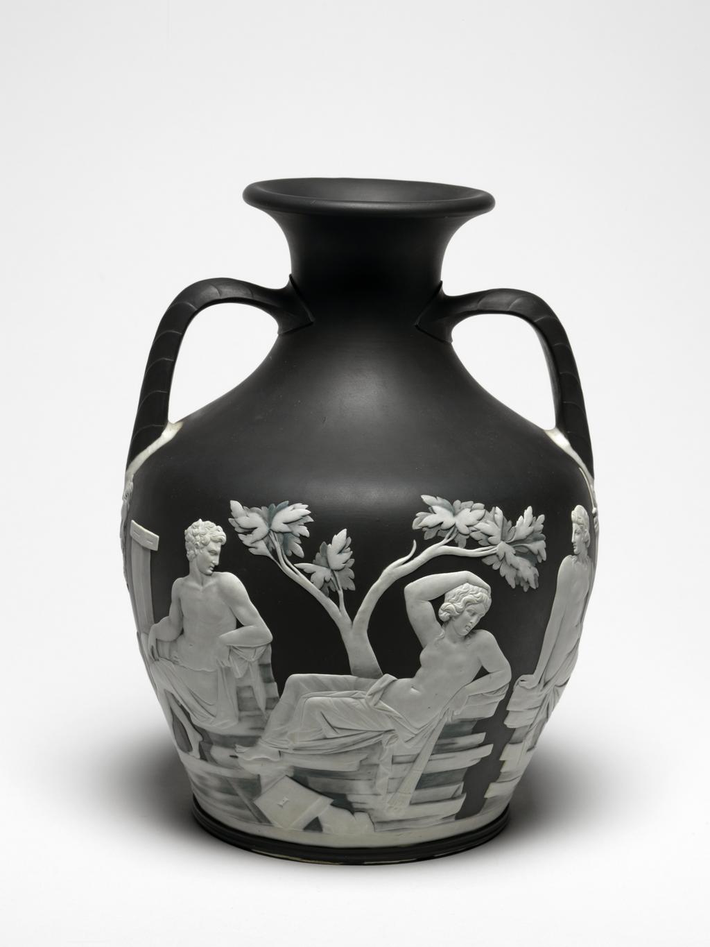 An image of Erasmus Darwin's Wedgwood Copy of the Portland Vase. Wedgwood, Josiah (English potter 1730-1795). Portland Vase copy, blue-black jasperware with applied white reliefs; on the sides classical scenes; on the base, the head of Paris. Squat ovoid body with incurved neck and everted rim, with two elbowed handles, and disk base. Decorated with two scenes separated by bearded male masks below the handles. Reading from left to right: Side 1. Two square pillars supporting an architrave, behind which is a small shrub. In front of the pillars a nude young man holding a drape behind him in his right hand, steps forward to take the arm of a partly draped woman who sits on the ground, looking back at him, and has a snake in her lap. Eros, holding a bow in his left hand and a torch in his right, flies overhead looking back to the young man. On the right, a bearded man stands in three-quarter profile to left, with his right foot on a heap of stones in front of a tree. He rests his chin on his right hand and his right elbow on his right thigh. To the right behind him there is a slender tree. Side 2. A square pillar with a capital, beside which sits a nude young man on a pile of rocks. He has a drape over his right leg, and looks to the right towards a woman, who reclines on pile of rocks in front of a tree. Her lower body is draped, and she holds a torch pointing downwards in her left hand, and has her right arm bent with the hand on her head. In front of her is a square stone with central hole and chamfered edge. On the right is a nude woman, seated on a separate pile of rocks, looking back towards the other two figures. She is partly draped, and holds a sceptre in her left hand. On the base, there is a spray of foliage above the head of a young man, in profile to right, wearing a Phrygian cap, and a cloak, and having his right forefinger to his lips. Solid blue-black jasper, thrown and turned, with applied press-moulded white reliefs, height 25.2 cm, width 19.1 cm. 1789. Neoclassi