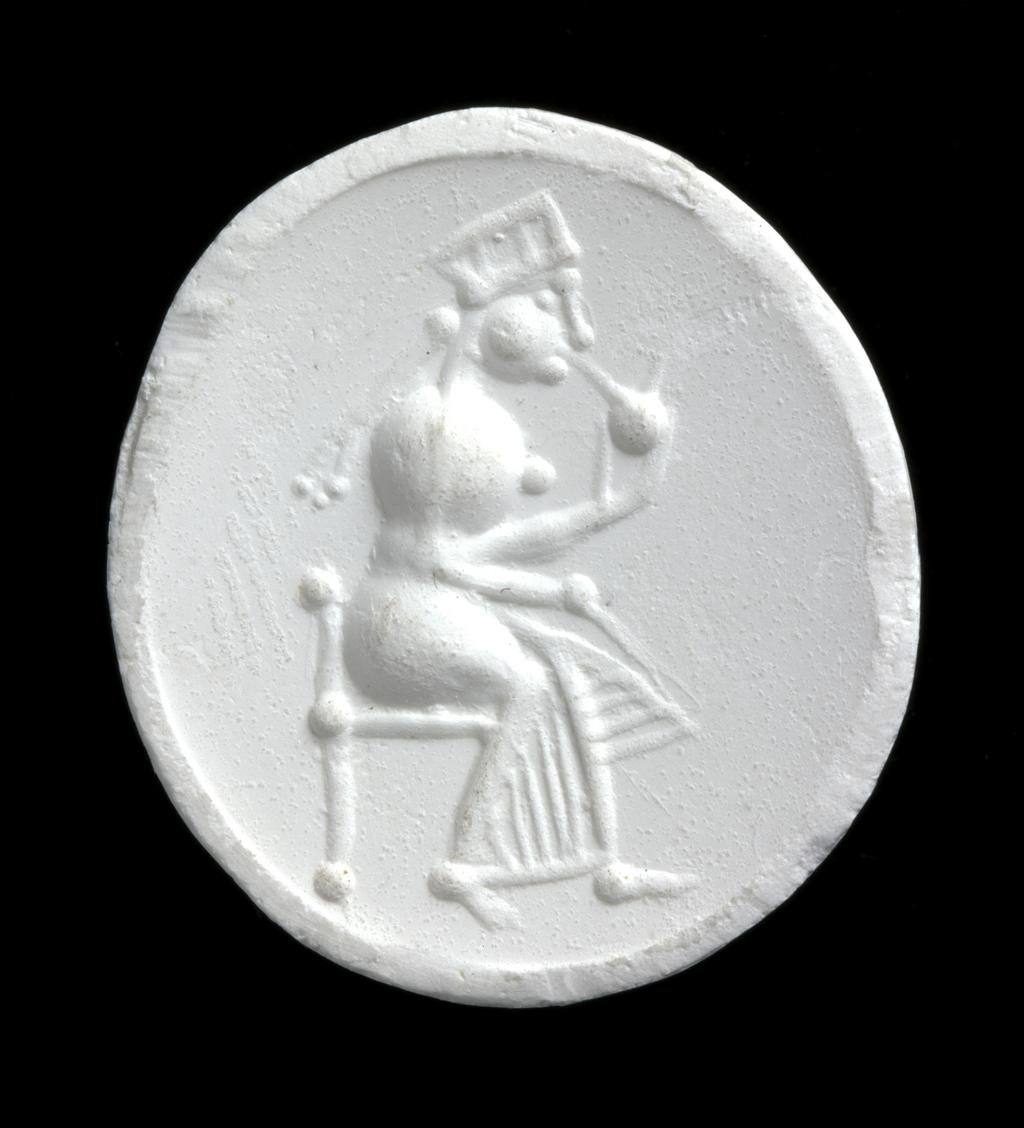 An image of Engraved gem impression. Intaglio. Ringstone. Production: Unknown maker, India, North-West Frontier. Seated woman, wearing chiton, head-dress and pigtails, holding round object - goddess Anahita? Intaglio cutting. Carnelian, height 23 mm, width 21 mm, depth 3 mm, circa 300-circa 250 B.C. Graeco Persian derivative. Alternative Number: gem catalogue number; O.38.1951.