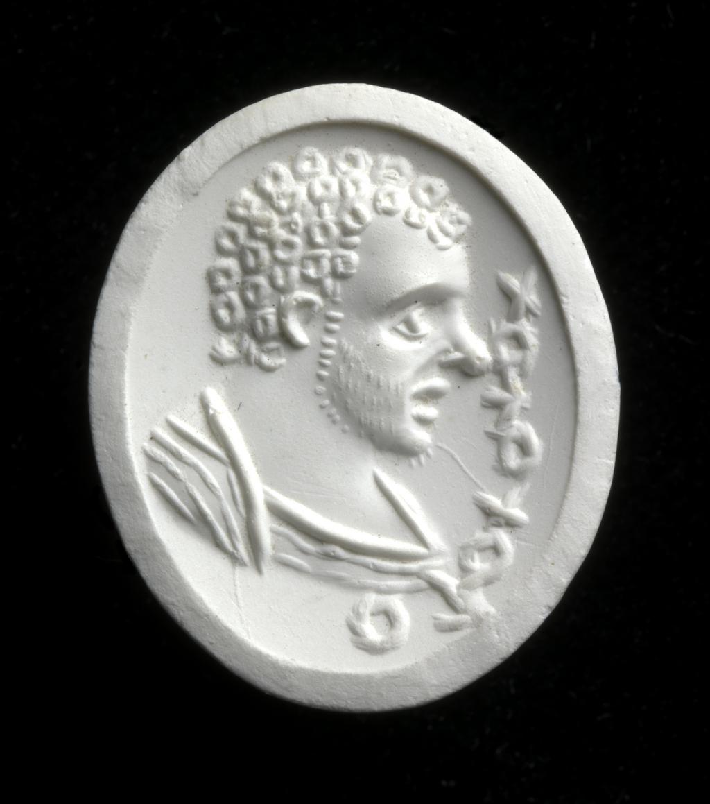 An image of Engraved gem. Ringstone. Intaglio. Male bust in profile to the right; the head has curly hair and the face has a light, stubbly beard and a prominent nose. The shoulders are draped. In front is a Bactrian inscription on palaeographic grounds. Intaglio cutting. Carnelian, height 18.5 mm, width 15 mm, circa 200-circa 400. Kushano-Sassanian. Alternative Number: gem catalogue number; CM.61.1967.