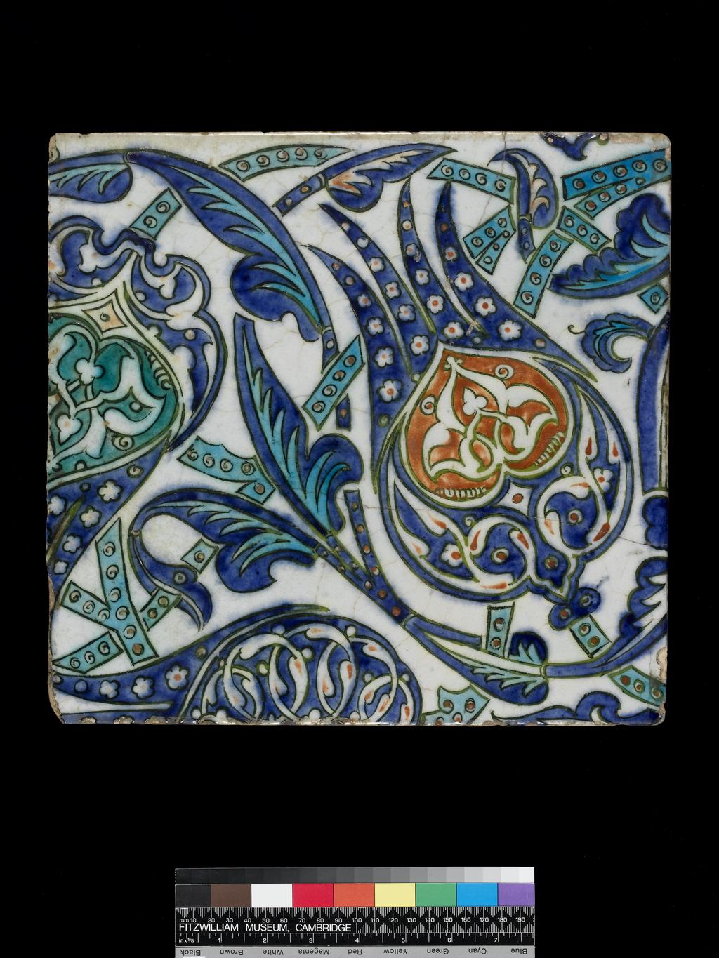 An image of Description: Tile, Stylised floral design. Very pale buff earthenware, the upper surface covered witha thin wash of white slip or opaque white glaze and painted in cobalt-blue, turquoise and pinkish-red with dark green outlines under a clear glaze. The outlines may be over-glaze. Production Place: Iznik (place) , Turkey (country) Dimensions: height: (whole): 32.7 cm, width: (whole): 34.4 cmDate: circa 1600 to 1630   