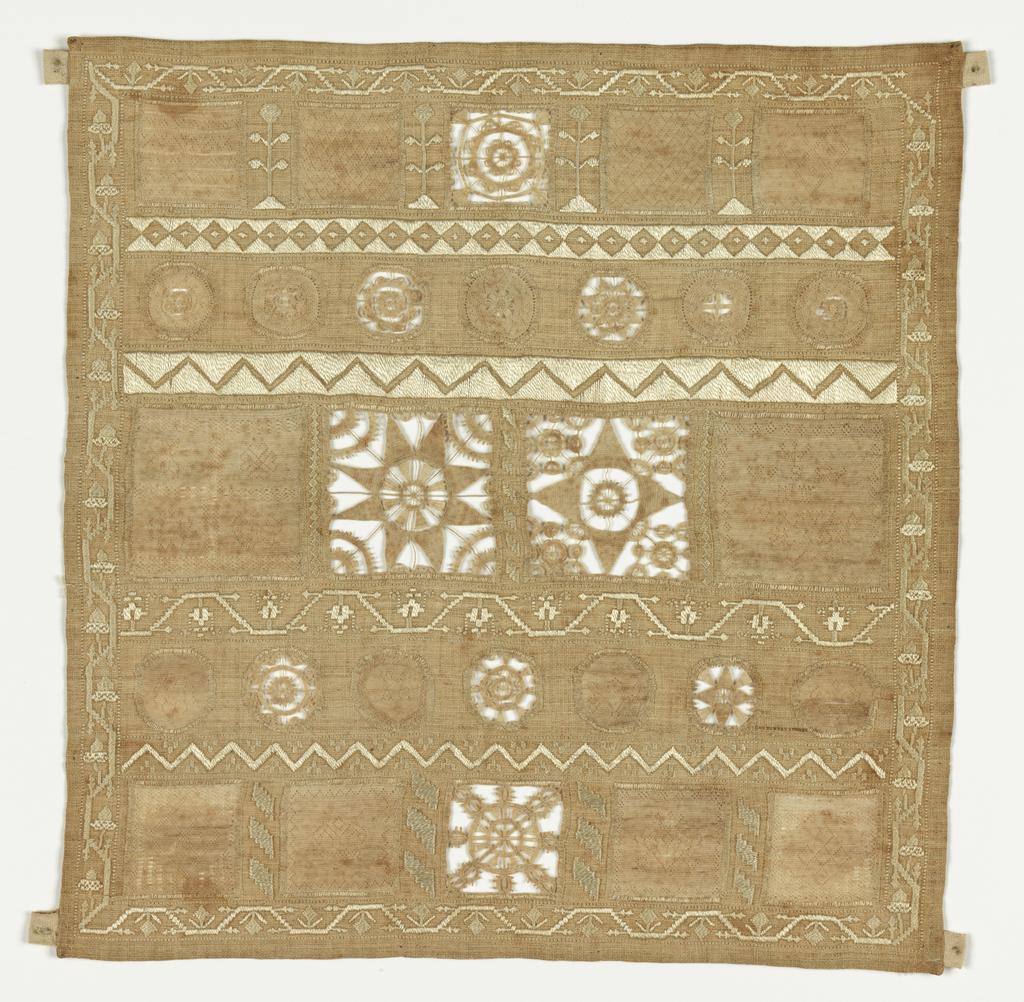 An image of Textiles. Whitework sampler. Slade, Ursula (English). The sampler is almost square in shape and is made up of inserted panels of hollie point and needle lace, neatly divided and bordered by repeat patterns in counted satin stitch. The sampler carries the inscription 'VrsVla/Slade' in the middle right panel. Linen embroidered with linen thread in satin and back stitch with hollie point and needle lace insertions. All the edges are hemmed. Length 21.75 cm, width 21 cm, 1728.