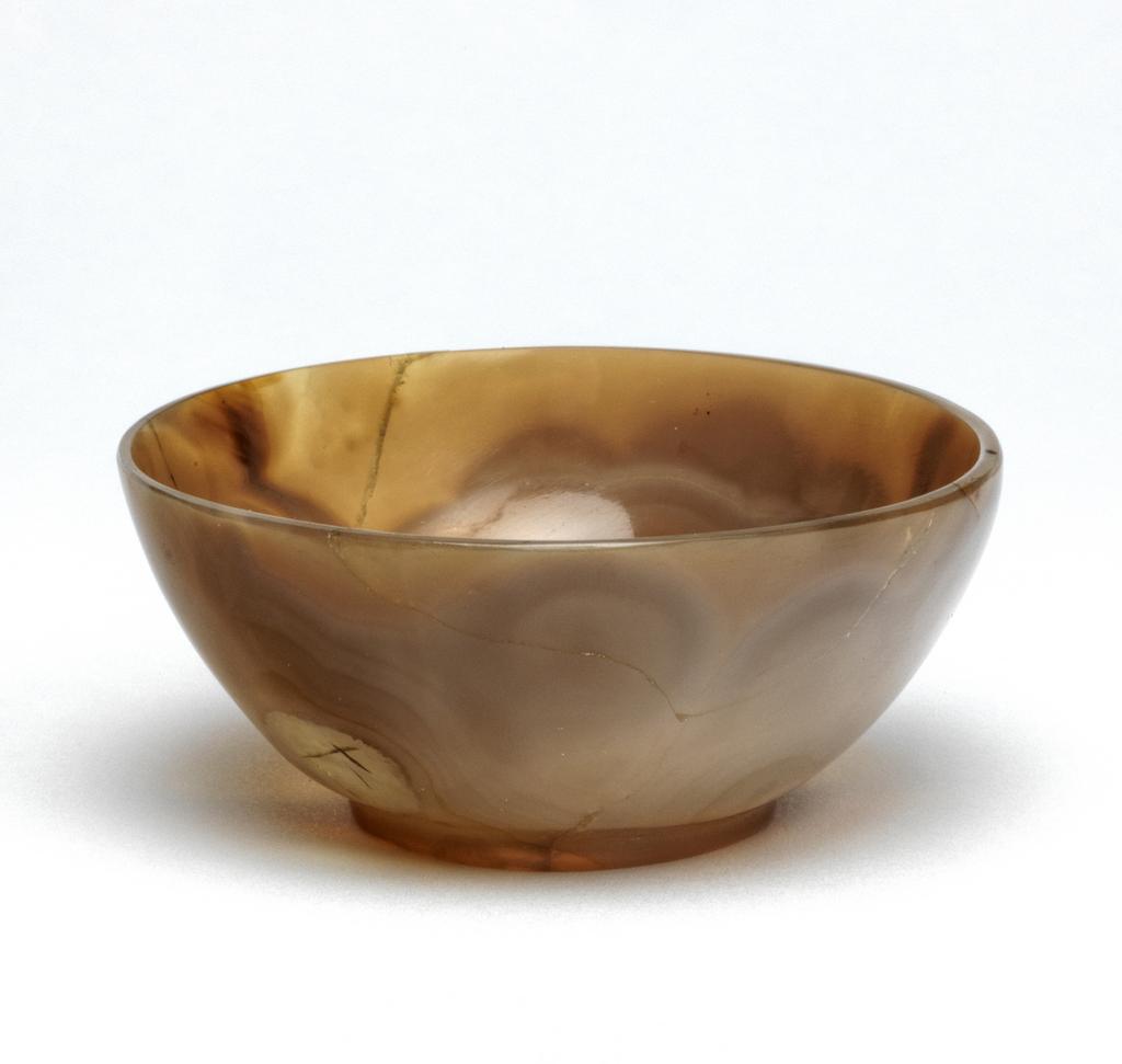 An image of A small chalcedony bowl, cracked and repaired. Unknown carver, China. 17th Century.