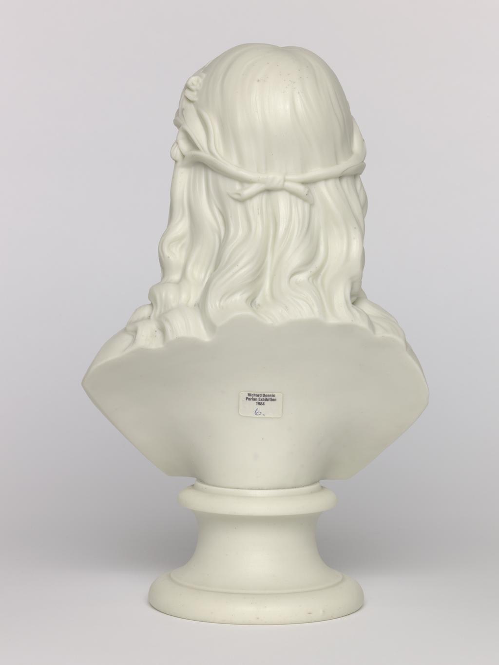 An image of Bust. Unknown lady. Unknown lady. Unknown manufacturer. Inscription: mark; reverse of bust; marked; P. Parian (porcelain), slip-cast, height, 27.5 cm, length, 16.8 cm, width, 10.9 cm, length, base, 10.9 cm. Acquisition Credit: Accepted by H. M. Government in lieu of Inheritance Tax from the estate of G. D. V. Glynn, and allocated to the Fitzwilliam Museum.