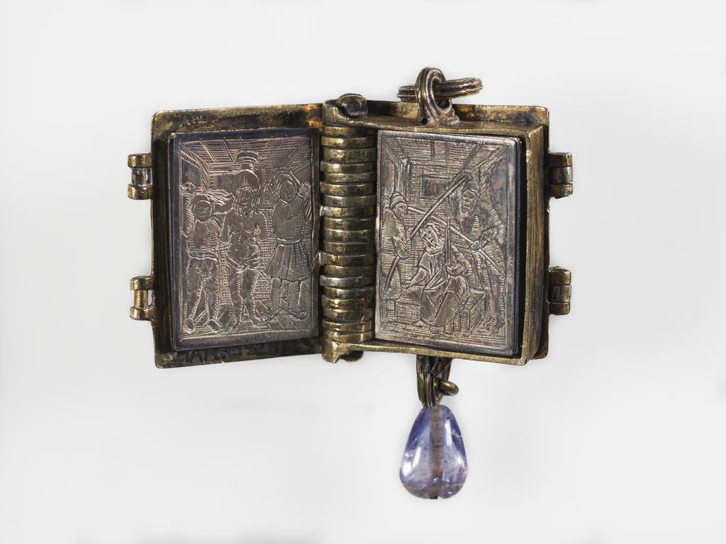 An image of Pendant Book. Jewellery/Pendant. Silver-gilt, with leaves made of silver and engraved with scenes from the Passion. Perhaps for attaching to a rosary, with pendant amethyst. Scenes: Annunciation, Nativity, Last Supper, Agony in the Garden, Kiss of Judas, Christ before Pilate, Scourying of Christ, The Mocking of Christ, Christ Carrying the Cross, the Erection of the Cross, Christ being Nailed to the Cross, the Crucifixion Deposition, Entombment, Resurrection, Christ Child Enthroned, a Pope and a female Saint. Silver-gilt, height, whole, 6.0 cm, width, whole, 2.8 cm, circa 1500- circa 1700. German.