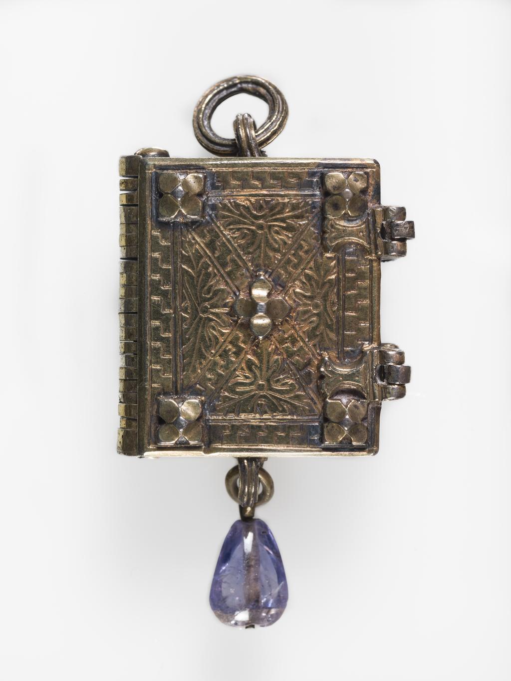 An image of Pendant Book. Jewellery/Pendant. Silver-gilt, with leaves made of silver and engraved with scenes from the Passion. Perhaps for attaching to a rosary, with pendant amethyst. Scenes: Annunciation, Nativity, Last Supper, Agony in the Garden, Kiss of Judas, Christ before Pilate, Scourying of Christ, The Mocking of Christ, Christ Carrying the Cross, the Erection of the Cross, Christ being Nailed to the Cross, the Crucifixion Deposition, Entombment, Resurrection, Christ Child Enthroned, a Pope and a female Saint. Silver-gilt, height, whole, 6.0 cm, width, whole, 2.8 cm, circa 1500- circa 1700. German.