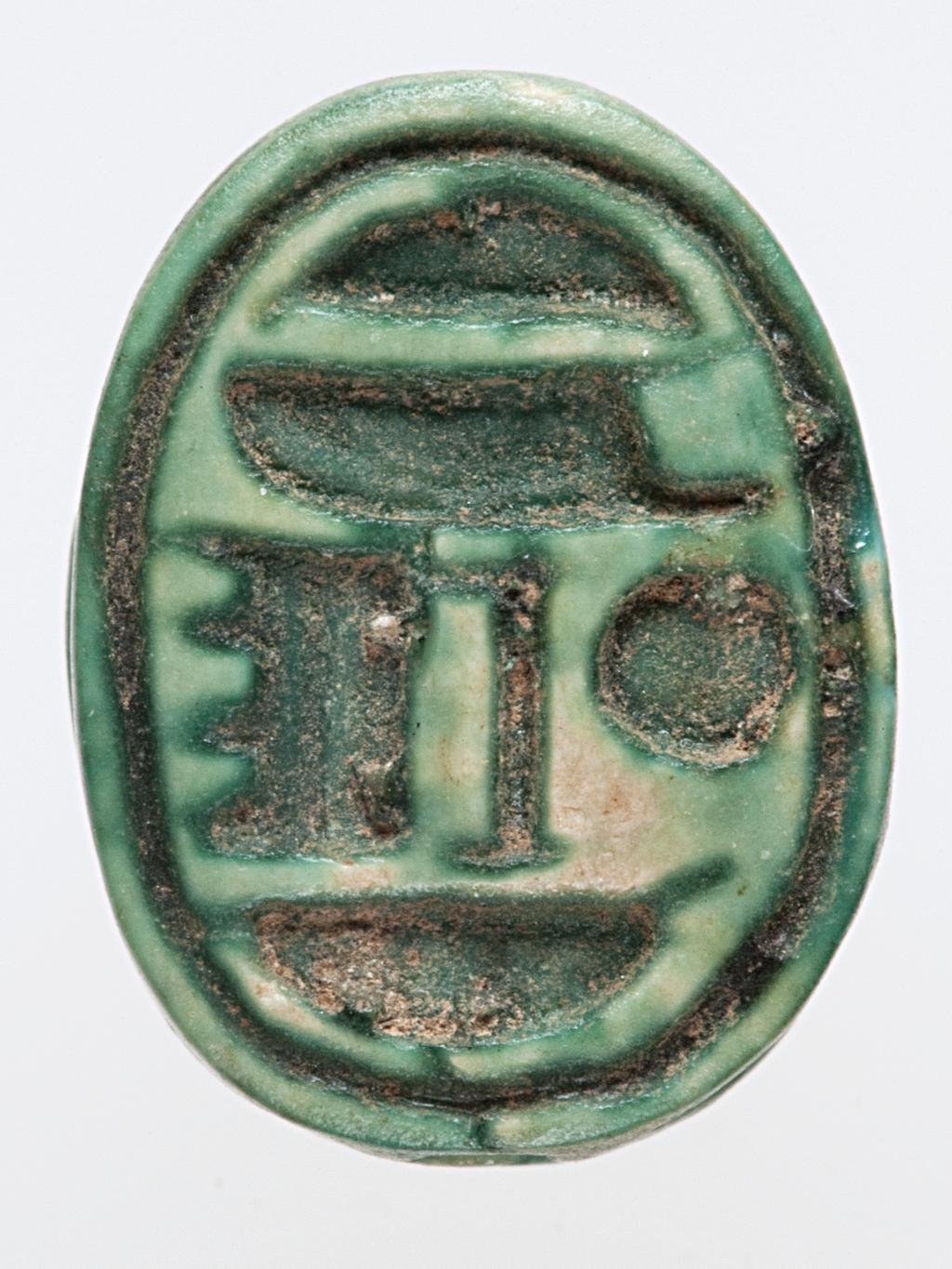 An image of Scarab. inscribed, with name of Amun-Re. Production Place: Egypt. Find Spot: Sedment, Egypt. Carved stone, either carnelian or glazed steatite, length 1.4 cm, 1479-1425 B.C. New Kingdom. Eighteenth Dynasty.