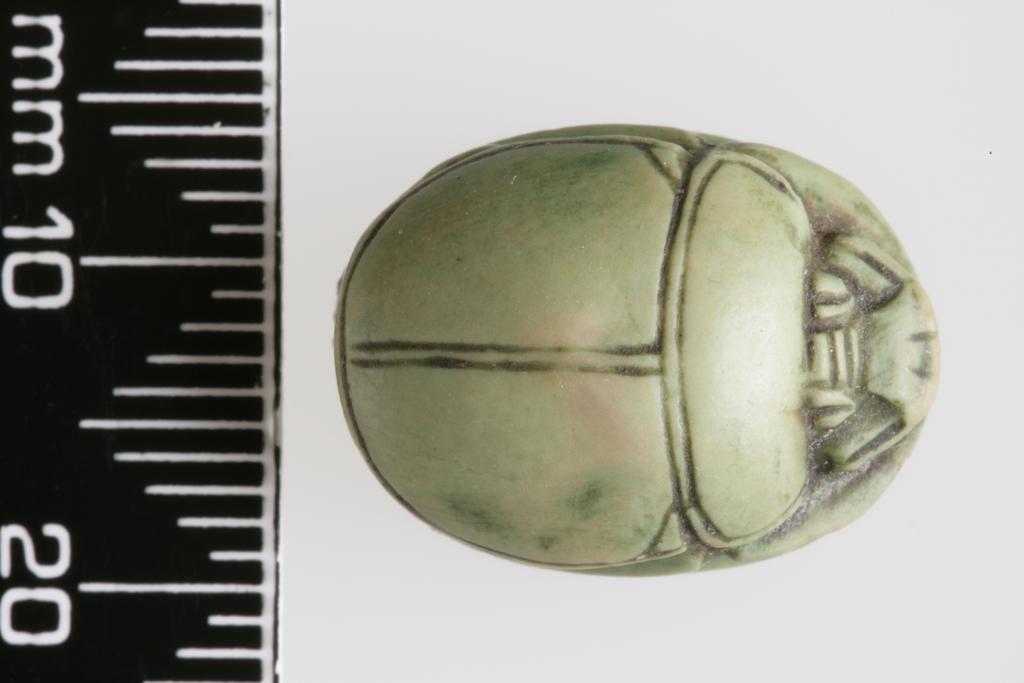 An image of Scarab. Inscribed, with the name 'Iy-ib', almost certainly a forgery. Production Place/Find Spot: Egypt. Depth 0.008 m, length 0.0175 m, width 0.013 m. 