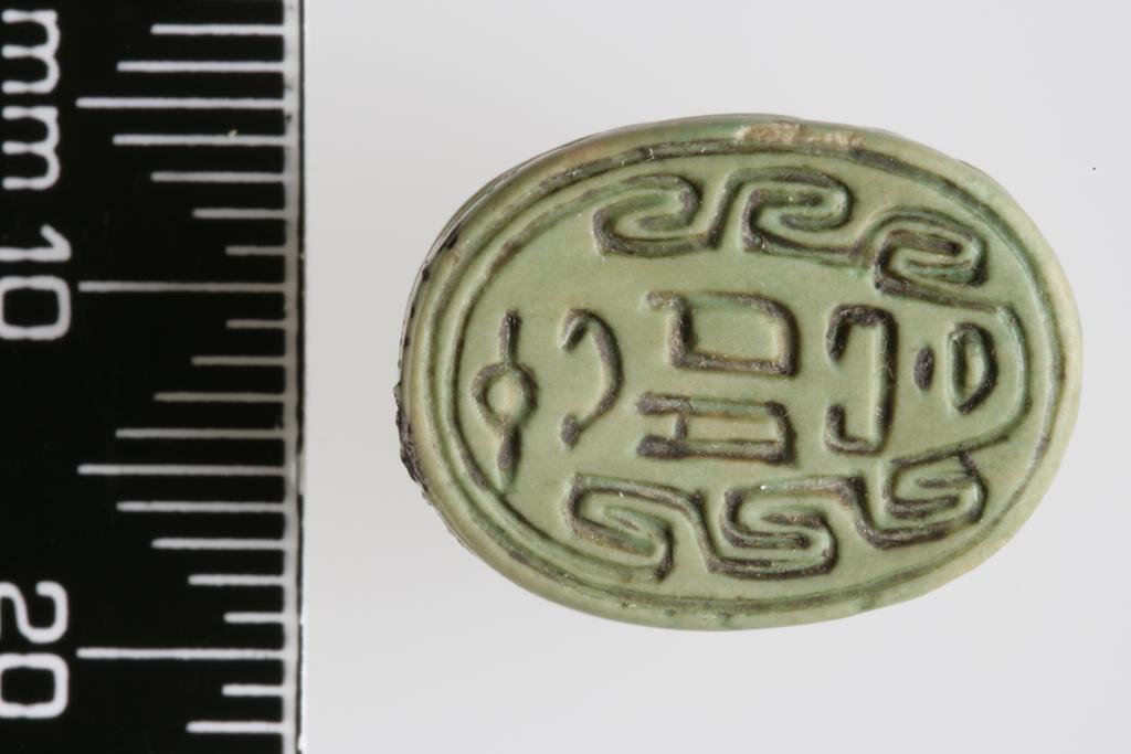An image of Scarab. Inscribed, with the name 'Iy-ib', almost certainly a forgery. Production Place/Find Spot: Egypt. Depth 0.008 m, length 0.0175 m, width 0.013 m. 
