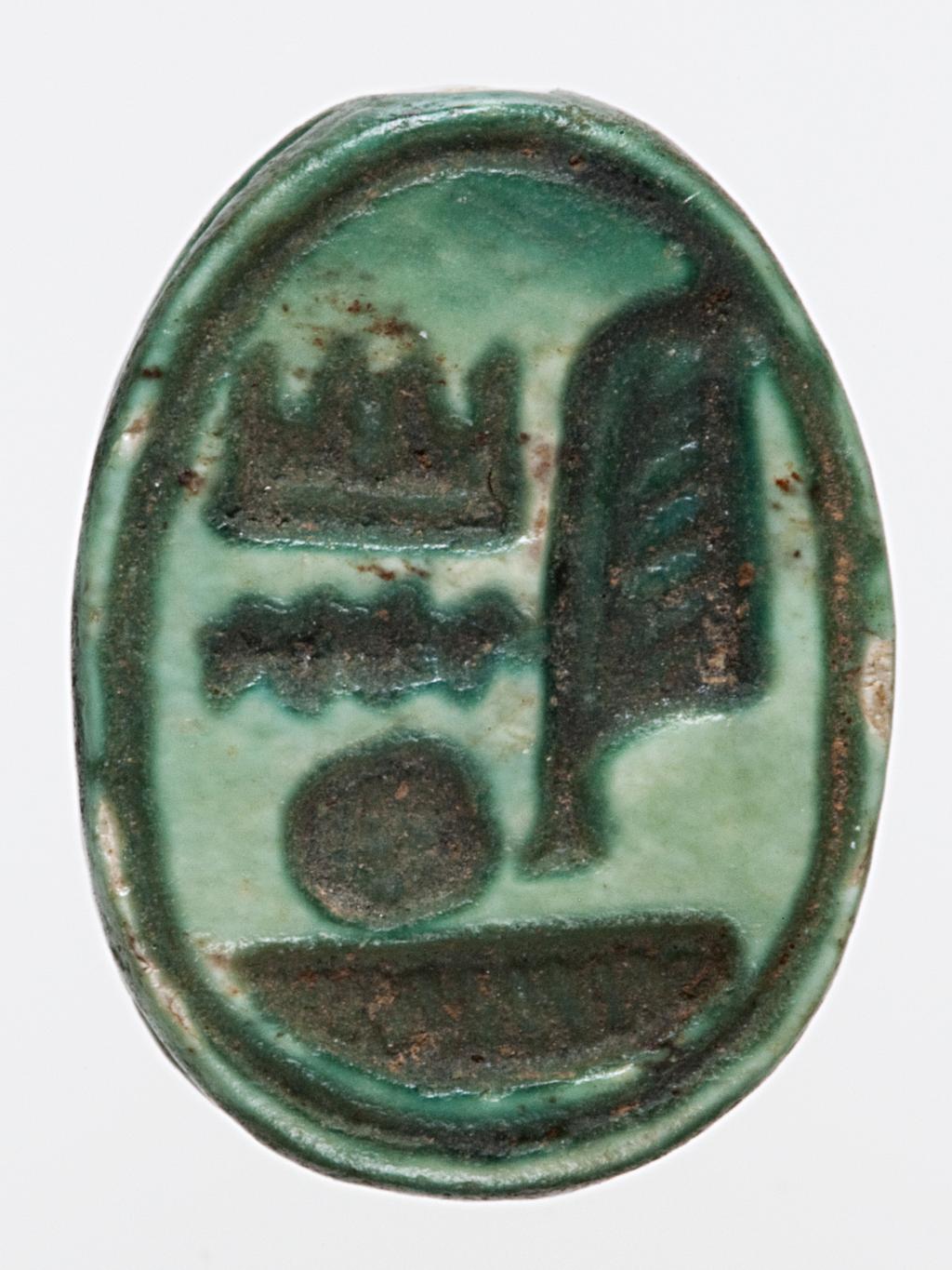 An image of Scarab. inscribed, with name of Amun-Re. Production Place: Egypt. Find Spot: Sedment, Egypt. Carved stone, either carnelian or glazed steatite, length 1.2 cm, 1479-1425 B.C. New Kingdom. Eighteenth Dynasty.