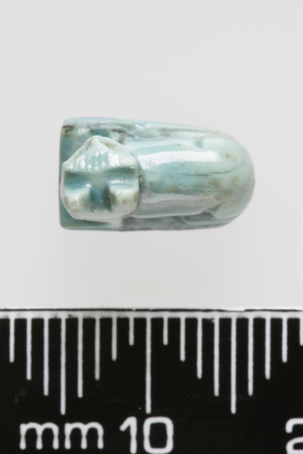 An image of Jewellery. Amulet. Cat, inscribed with sun disks and uraei on base. Production Place/Find Spot: Egypt. Length 0.011 m, width 0.01 m. 